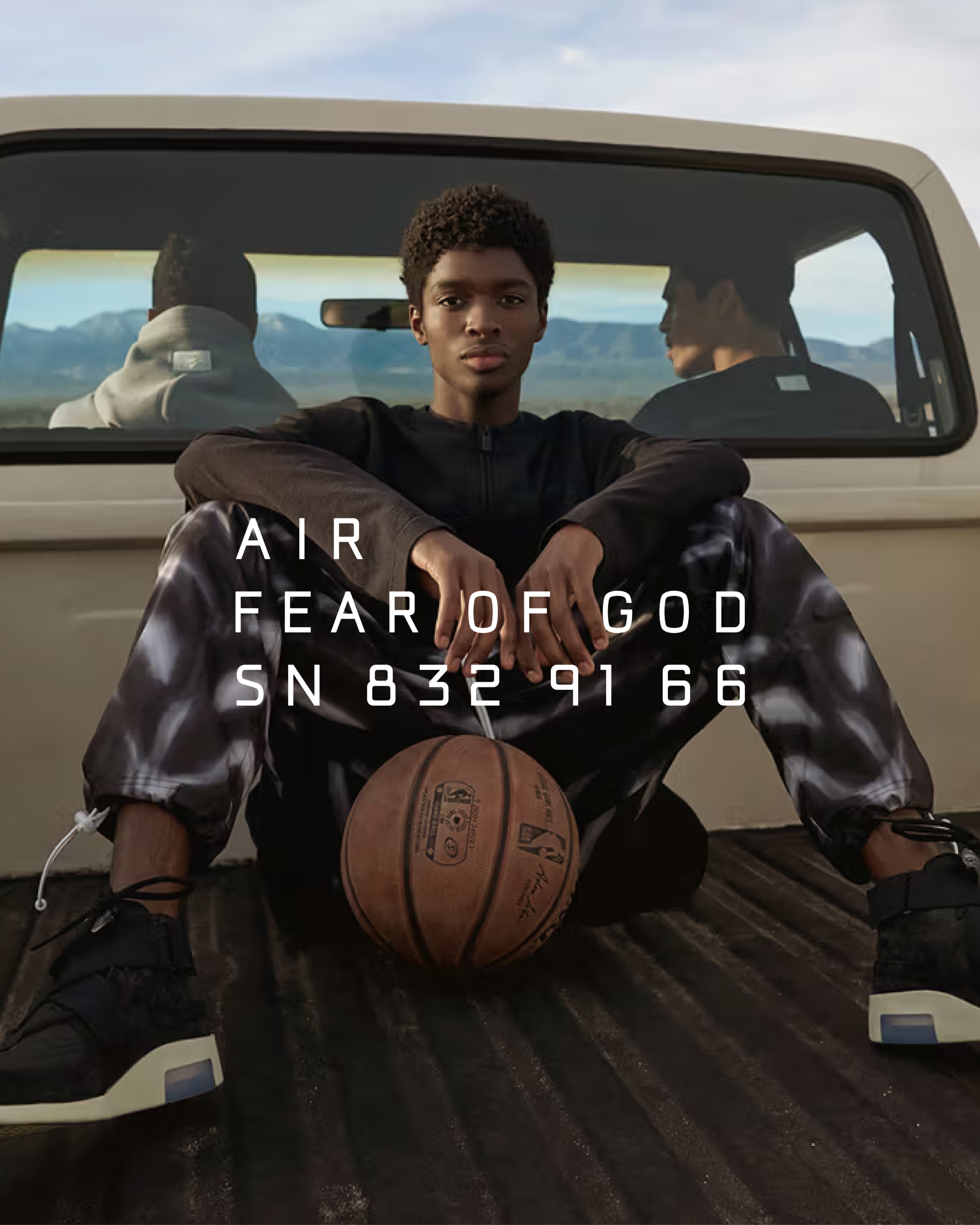 Basketball player back of pickup truck in the mountain Nike Air Fear of God logo brand identity by WØRKS